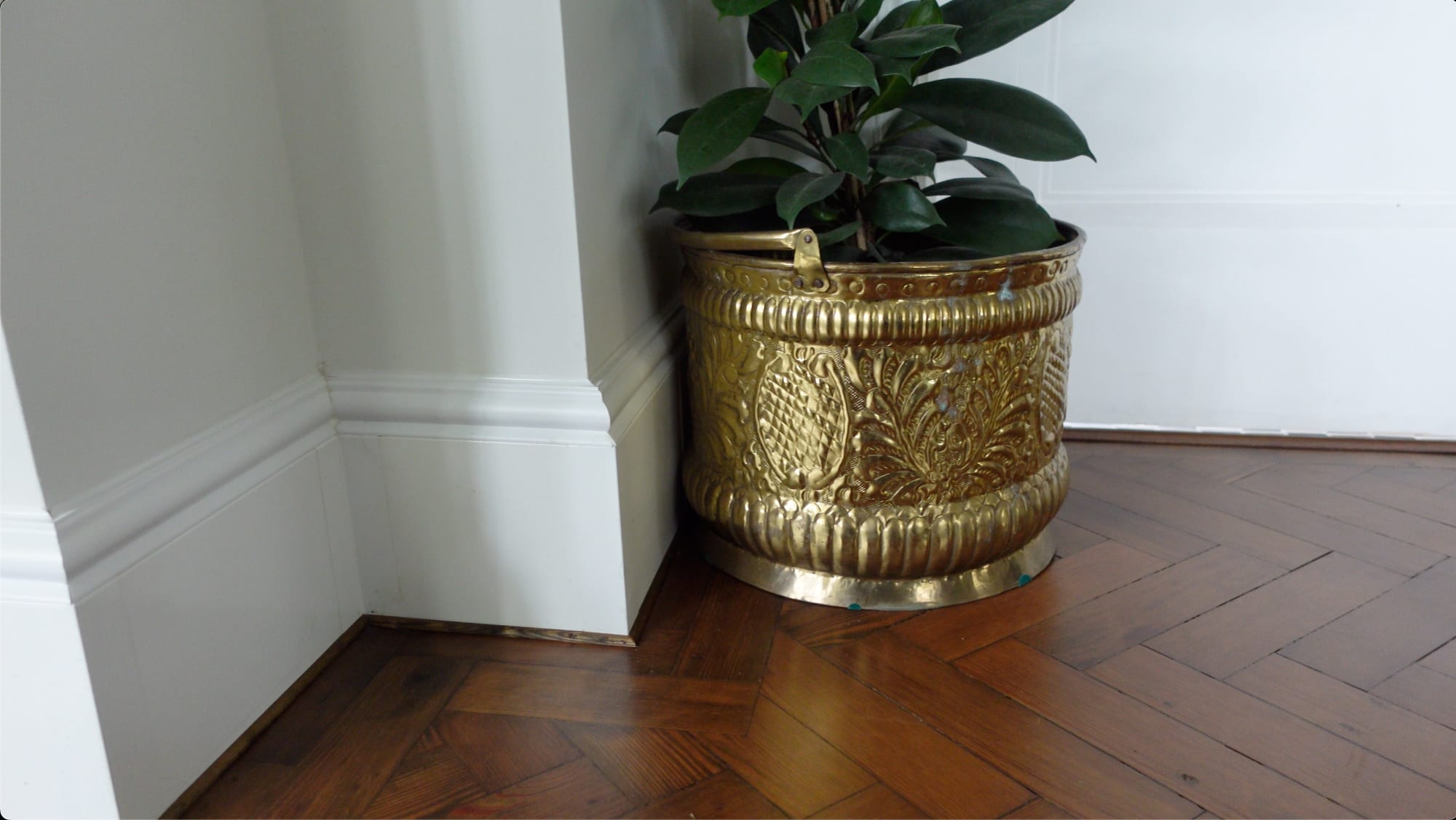 A side-by-side demonstration of a dirty trench heater grille vs a clean ThermaSkirt threshold