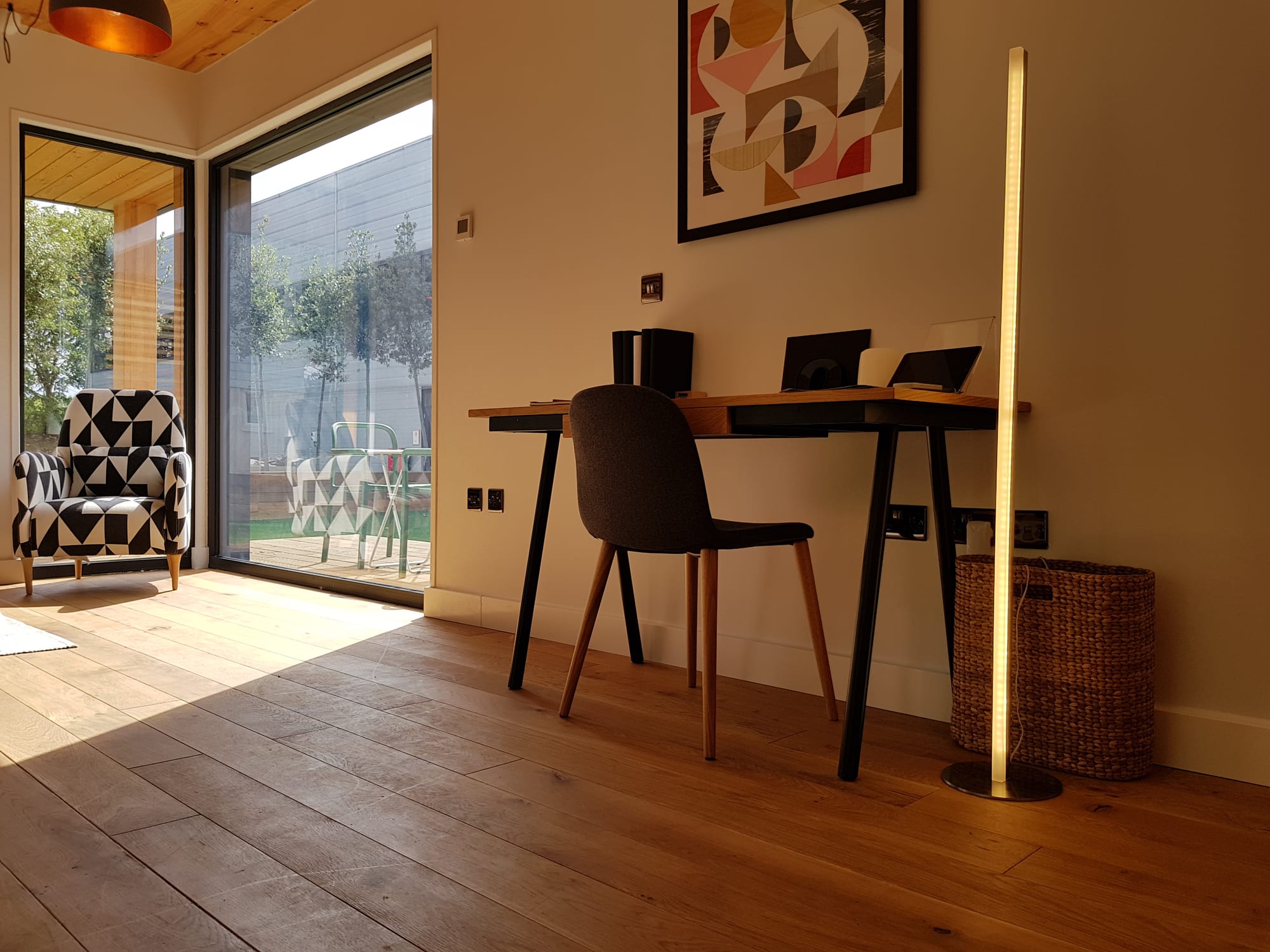 ThermaSkirt installed in a modern open-plan living room with floor-to-ceiling glazing