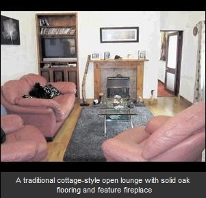 A traditional cottage-style open lounge with solid oak flooring and feature fireplace