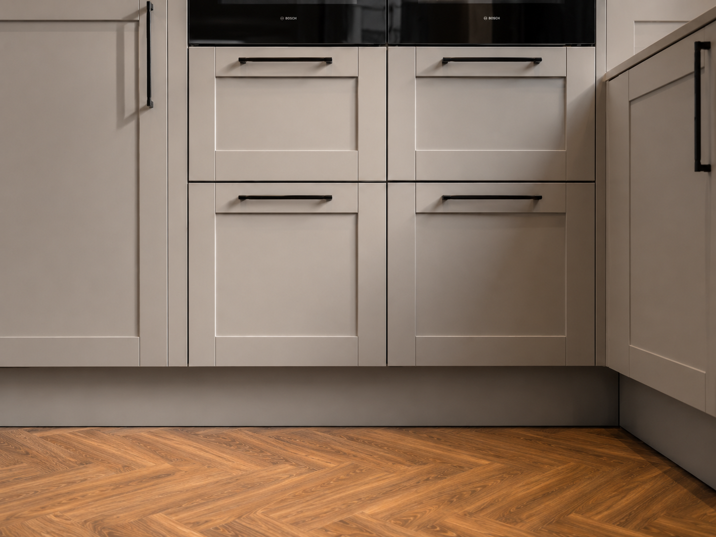 ThermaSkirt kitchen plinth in a grey-blue finish running along the base of the cabinetry